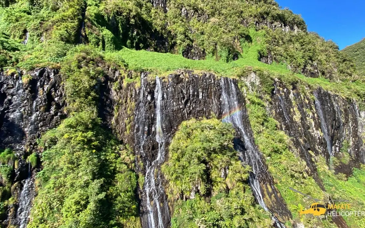Waterfalls on the green walls of a Reunion cirque seen from the air
